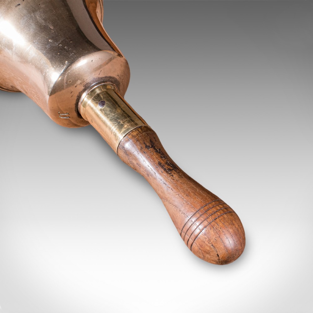 Victorian hand bell featuring a polished brass bell body with a turned beech handle set on a circular wooden stand. View IX