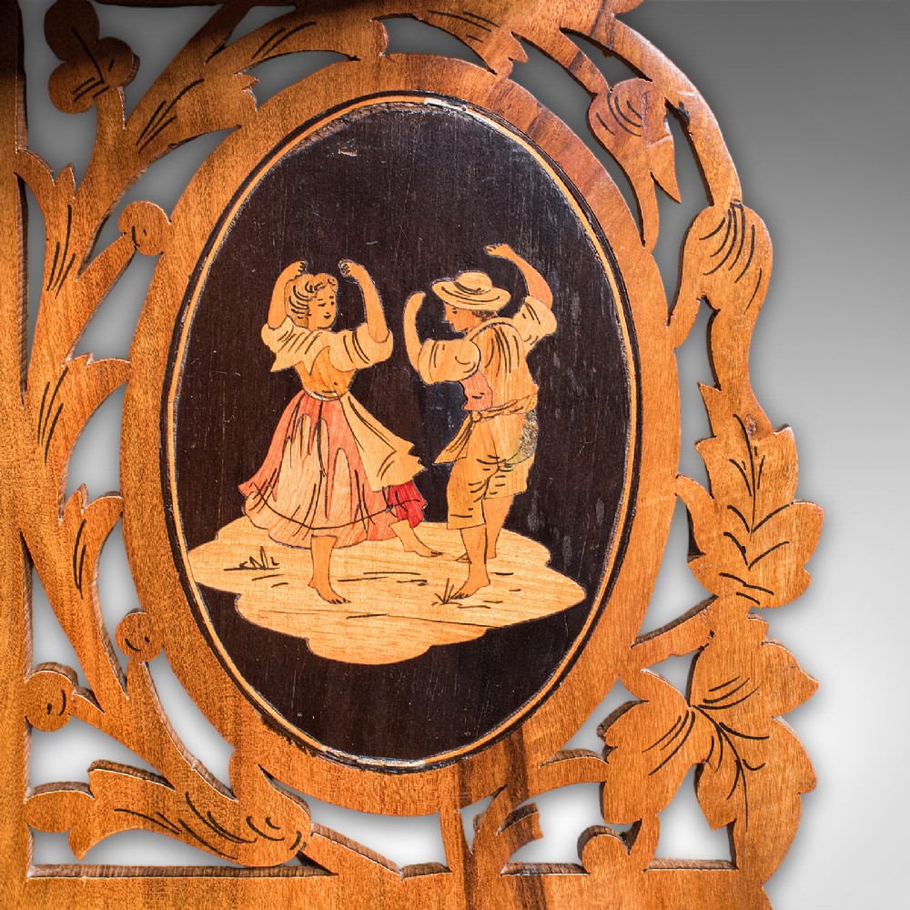 A Victorian Italian walnut corner display shelf featuring two tiers, openwork foliage fretwork borders, and oval marquetry panels depicting folk dancers. View VIII