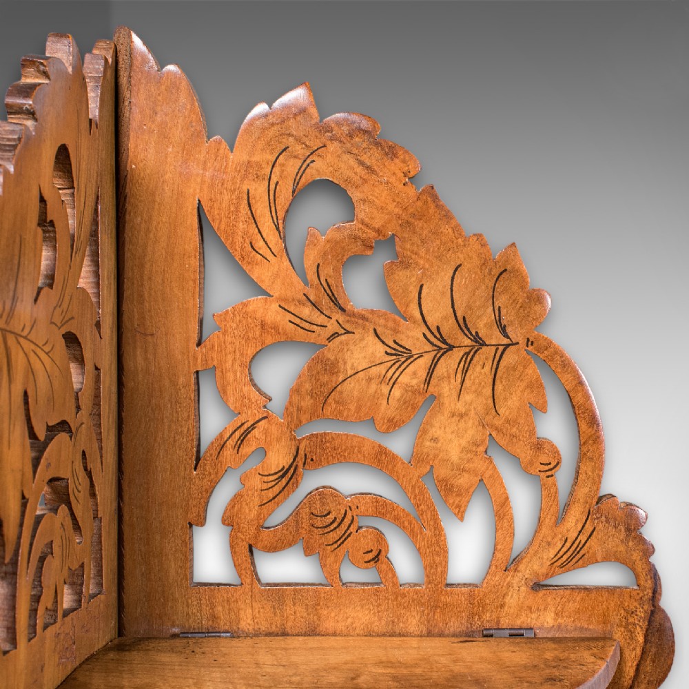 A Victorian Italian walnut corner display shelf featuring two tiers, openwork foliage fretwork borders, and oval marquetry panels depicting folk dancers. View IX