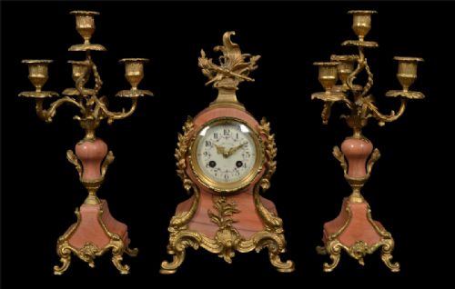 French Three Piece Pink Marble and Gilt Metal Clock Set