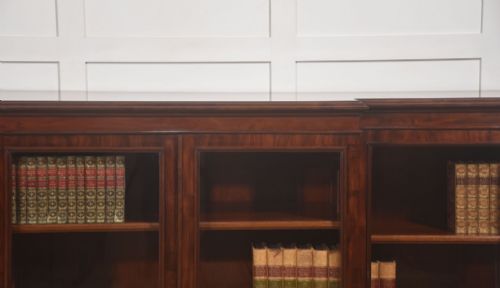 fig 2. A 19th-century mahogany breakfront library bookcase featuring four glass-panelled doors, adjustable interior shelving, and a moulded cornice.