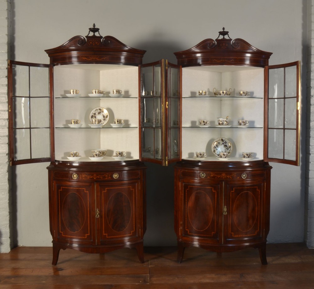 Pair of mahogany inlaid bow fronted display cabinets by Shapland and Petter 