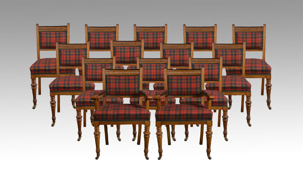 Set of fourteen oak dining chairs