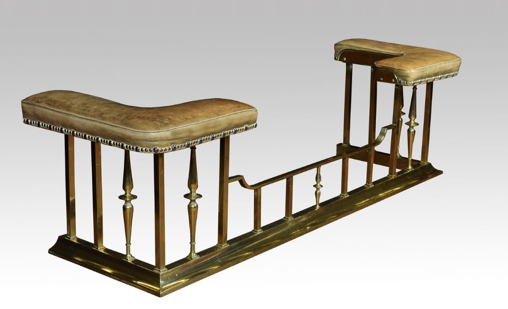 Early 20th century brass and leather upholstered club fender