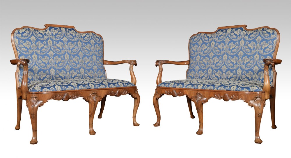 Pair of Walnut framed settees in the George II manner