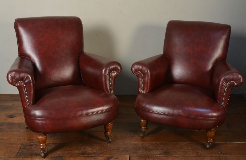 Pair of dark red leather arm chairs 