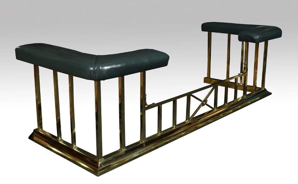 Early 20th century brass and leather upholstered club fender