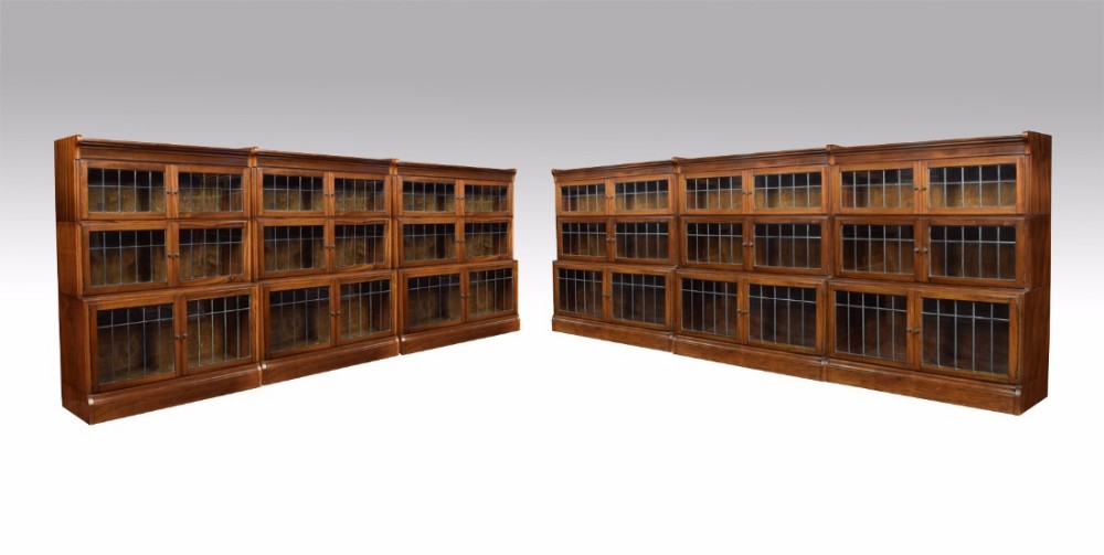 Set of six walnut three sectional bookcases by Minty