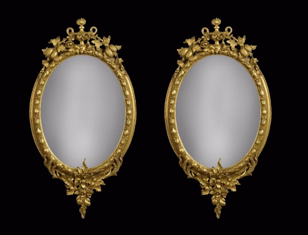 Pair of gilt oval wall mirrors