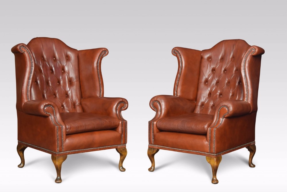 Pair of Leather upholstered wingback armchairs