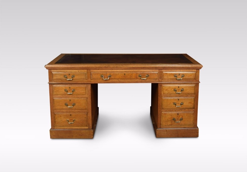 Oak twin pedestal desk by Maple & Co