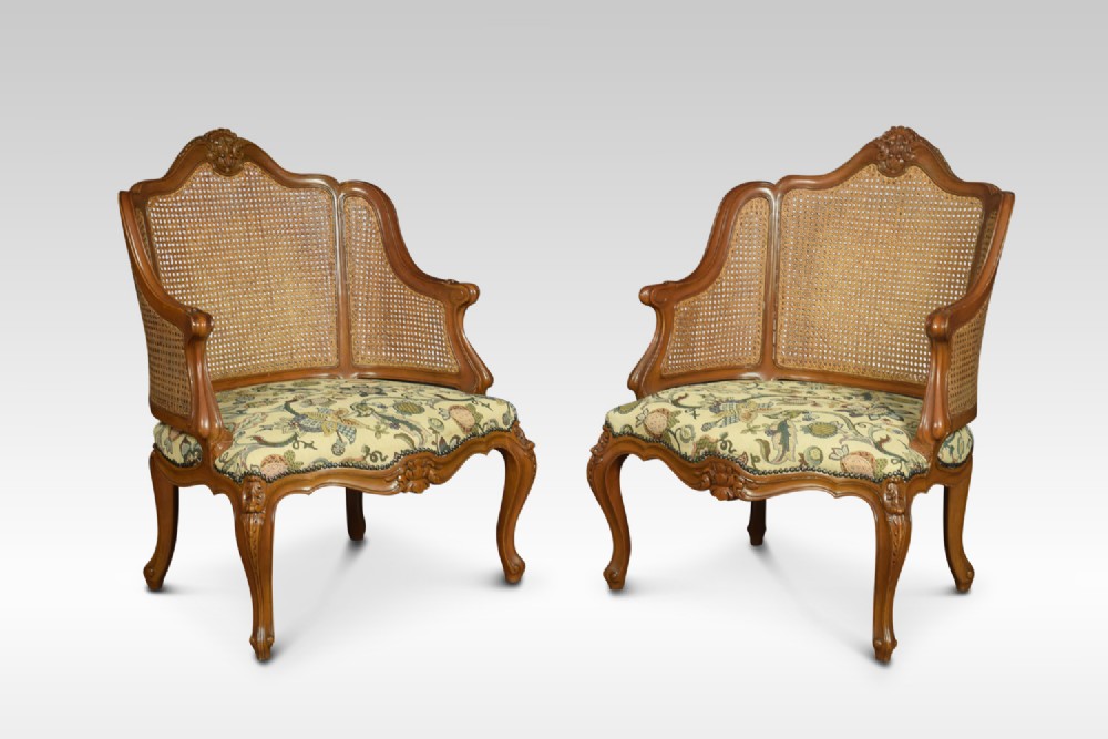 Pair of Louis XV style double caned bergere armchairs