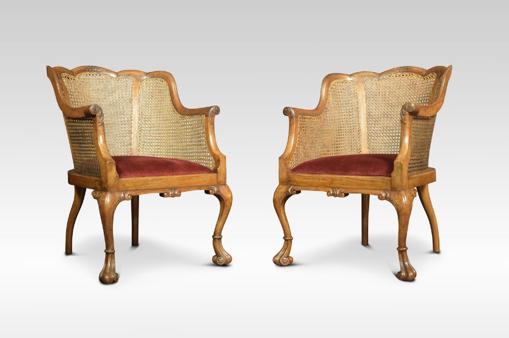 Pair of walnut bergere arm chairs