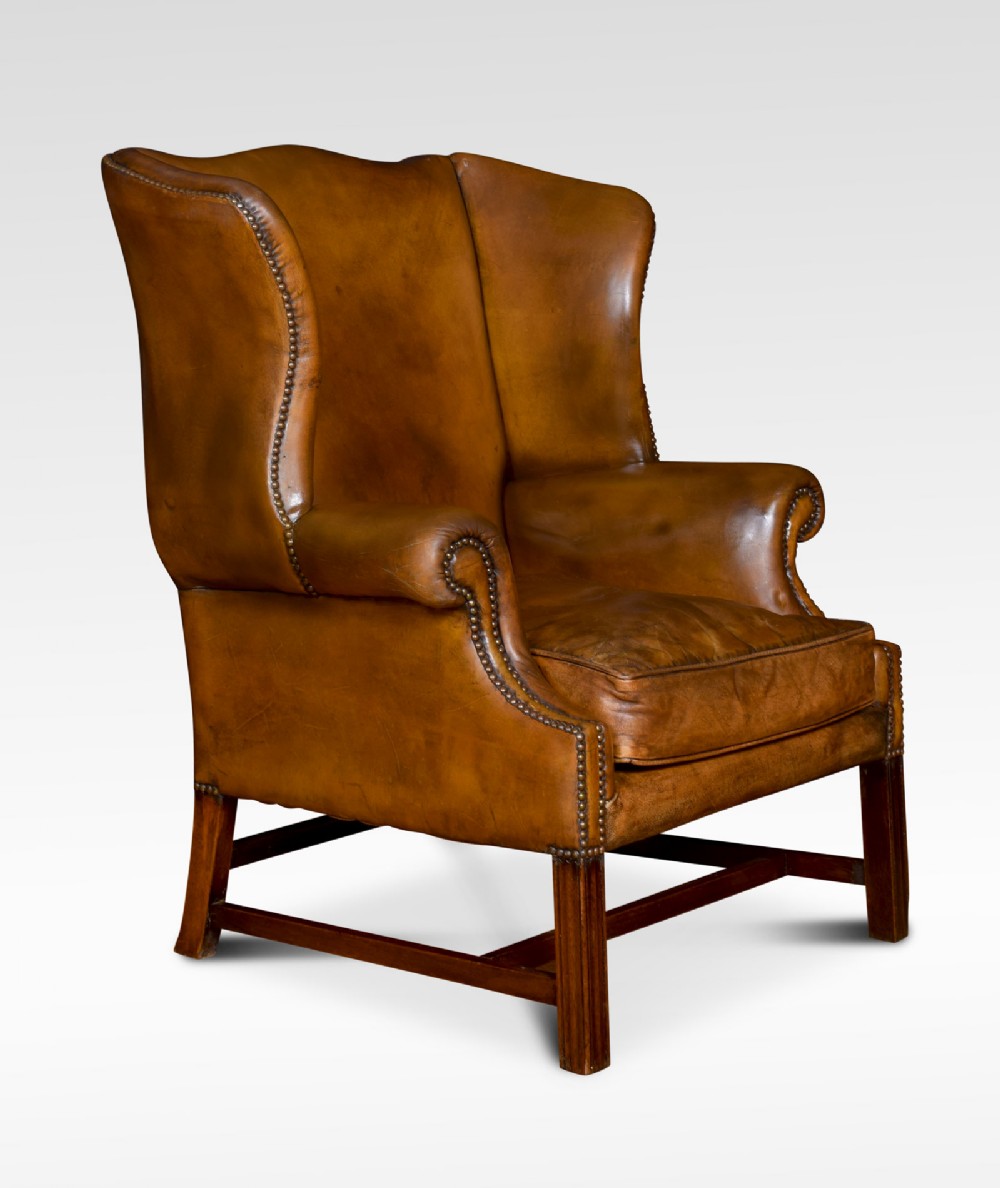 Brown leather upholstered wingback armchair