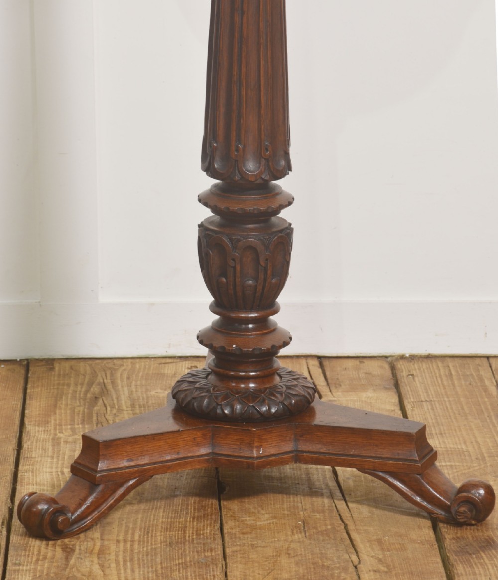 A 19th-century carved oak plant stand featuring a circular dish top, fluted central column, and a tripod base with carved scroll feet. View IV