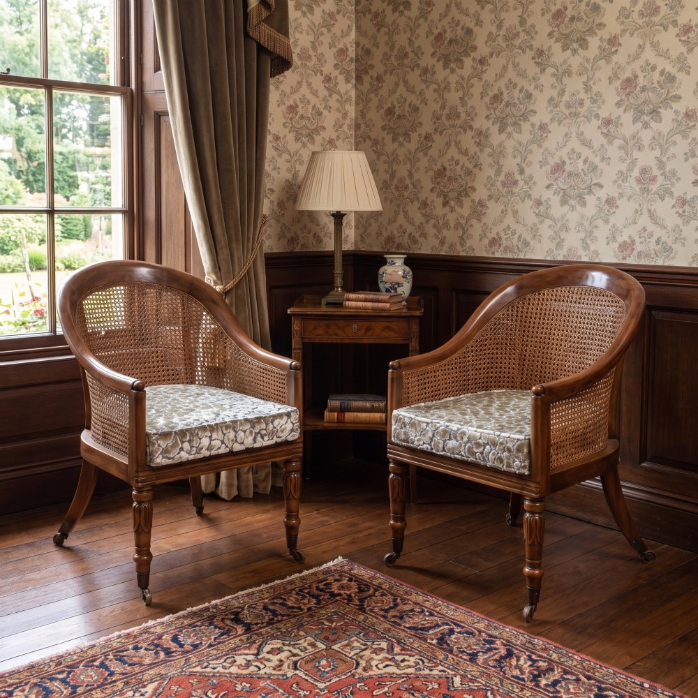 Pair of Regency style mahogany tub chairs featuring woven cane backs, upholstered cushions, turned legs, and brass castors. View II