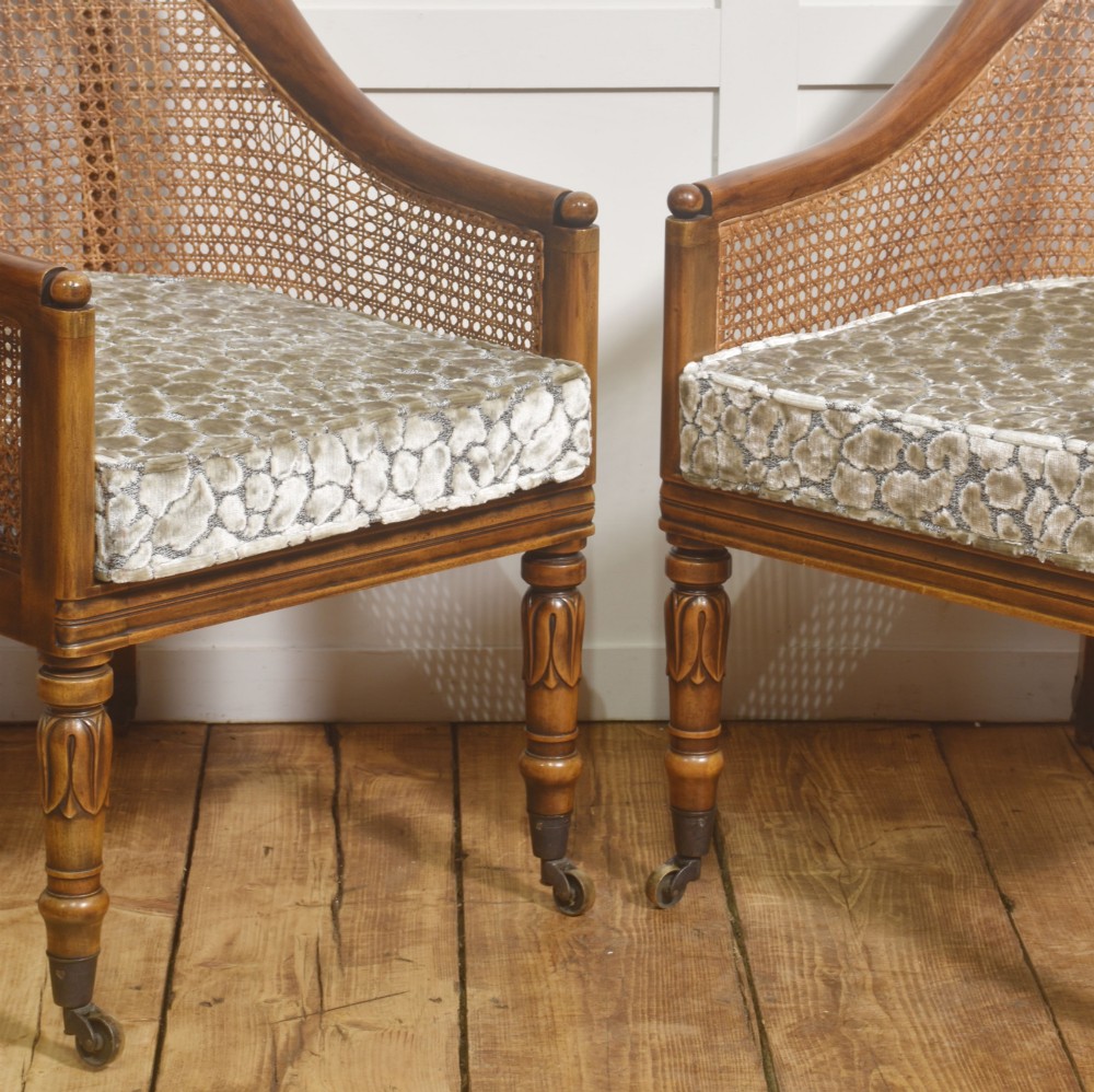 Pair of Regency style mahogany tub chairs featuring woven cane backs, upholstered cushions, turned legs, and brass castors. View IV