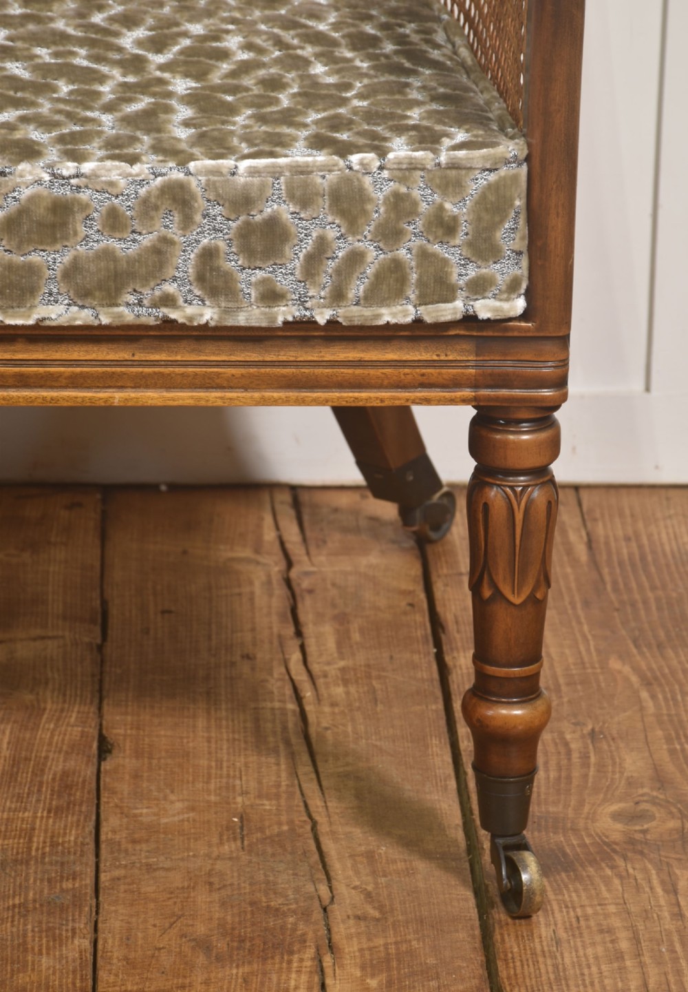Pair of Regency style mahogany tub chairs featuring woven cane backs, upholstered cushions, turned legs, and brass castors. View IX