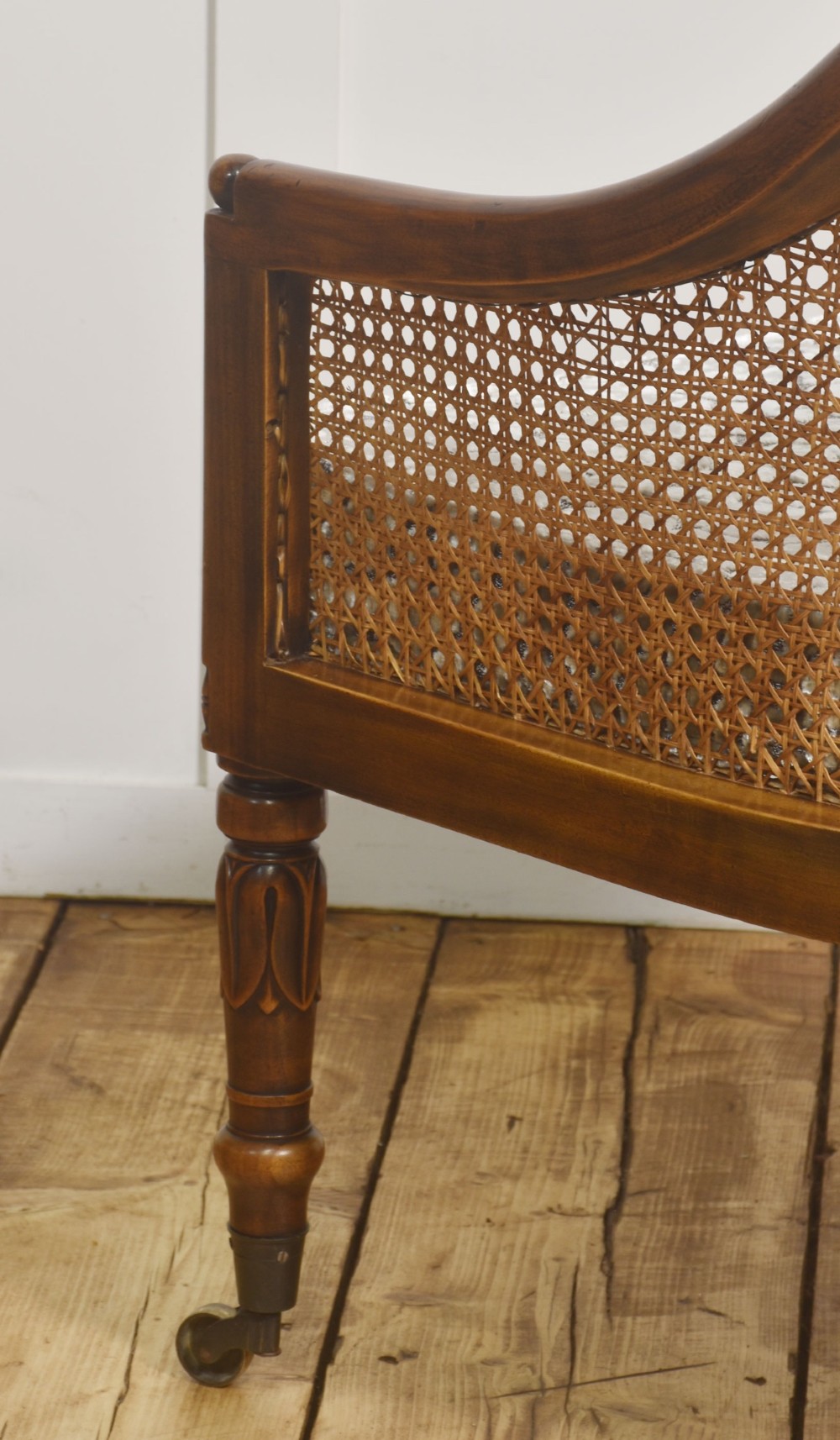 Pair of Regency style mahogany tub chairs featuring woven cane backs, upholstered cushions, turned legs, and brass castors. View XI