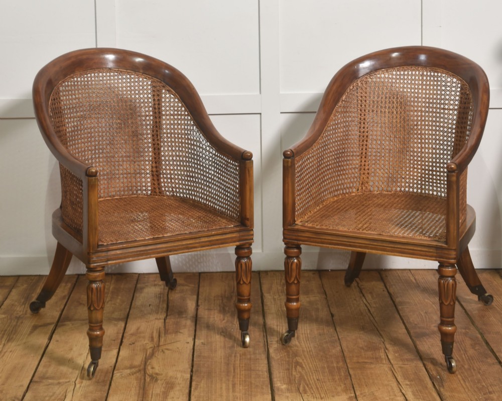 Pair of Regency style mahogany tub chairs featuring woven cane backs, upholstered cushions, turned legs, and brass castors. View XII