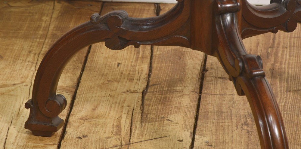 A dark carved mahogany tripod occasional table featuring a scalloped piecrust top, fluted central pedestal, and carved cabriole legs. View IV