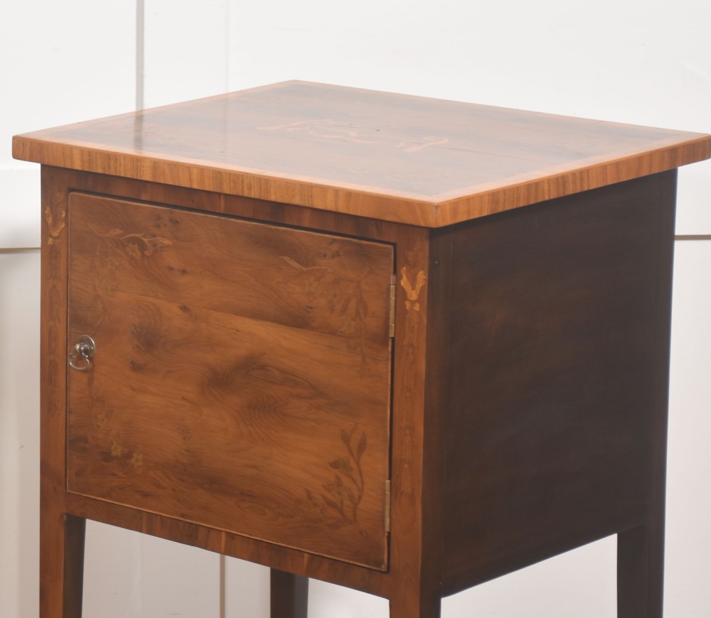 A matching pair of tall, slim mahogany Sheraton style bedside cabinets featuring floral marquetry inlay on single cupboard doors and square tapered legs. View V