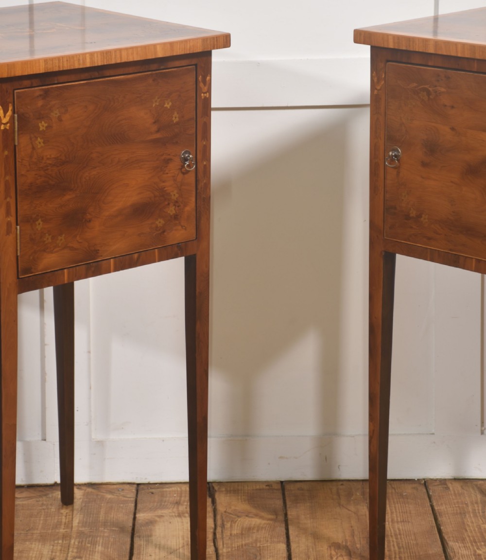 A matching pair of tall, slim mahogany Sheraton style bedside cabinets featuring floral marquetry inlay on single cupboard doors and square tapered legs. View VI