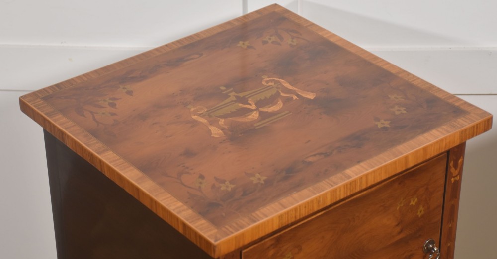A matching pair of tall, slim mahogany Sheraton style bedside cabinets featuring floral marquetry inlay on single cupboard doors and square tapered legs. View IX