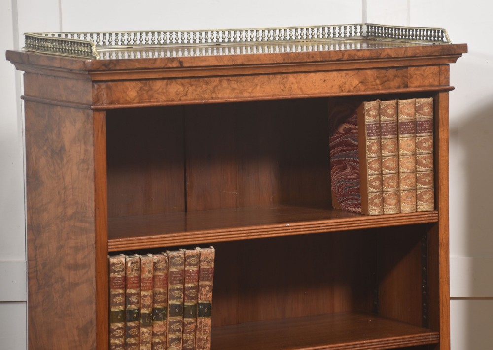 A pair of low burr walnut open bookcases featuring brass galleries along the top and adjustable interior shelves. View IV