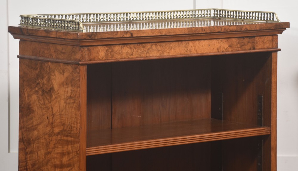 A pair of low burr walnut open bookcases featuring brass galleries along the top and adjustable interior shelves. View VIII