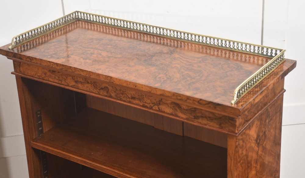 A pair of low burr walnut open bookcases featuring brass galleries along the top and adjustable interior shelves. View XI