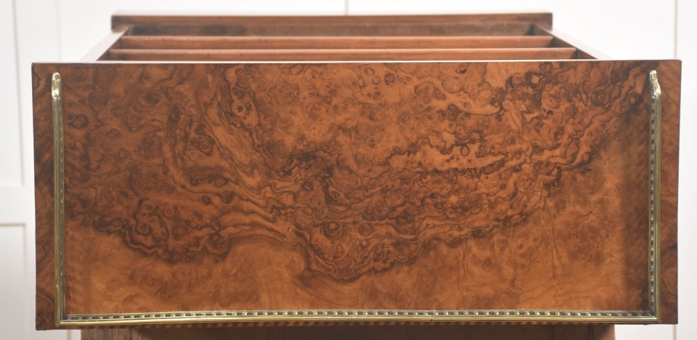 A pair of low burr walnut open bookcases featuring brass galleries along the top and adjustable interior shelves. View XII