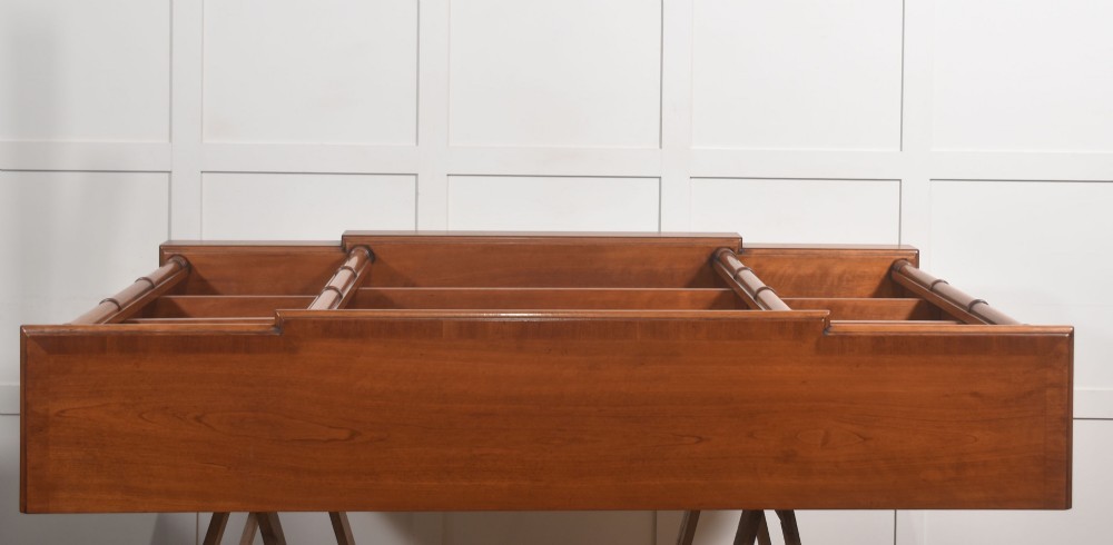 A low Regency style mahogany breakfront open bookcase featuring three shelving sections separated by reeded pilasters. View IX