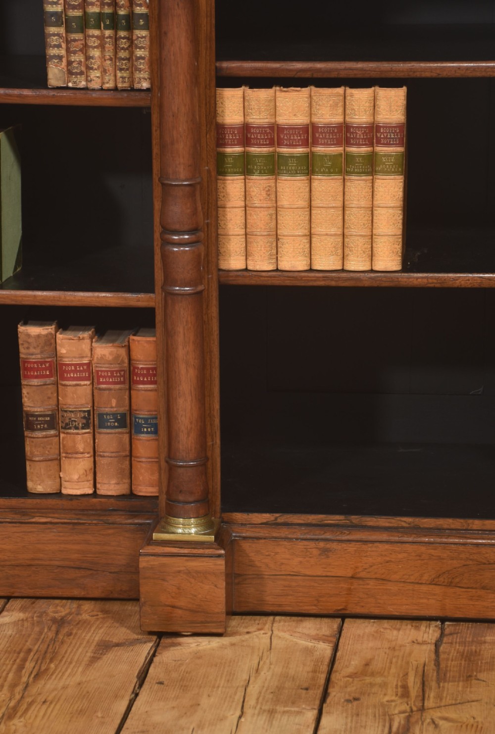 A Regency period open breakfront bookcase crafted from dark rosewood with brass mounted column pilasters and adjustable shelves. View IV