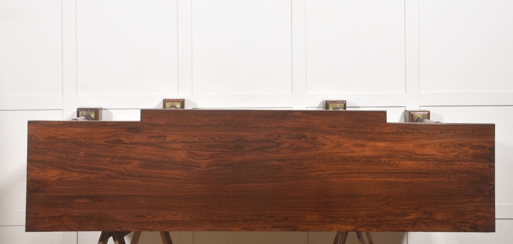 A Regency period open breakfront bookcase crafted from dark rosewood with brass mounted column pilasters and adjustable shelves. View XI