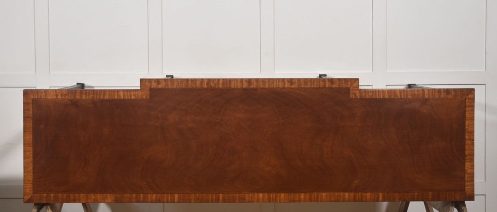 A mahogany breakfront hall table featuring satinwood crossbanding, three drawers with brass handles, and four tapered square legs. View XI