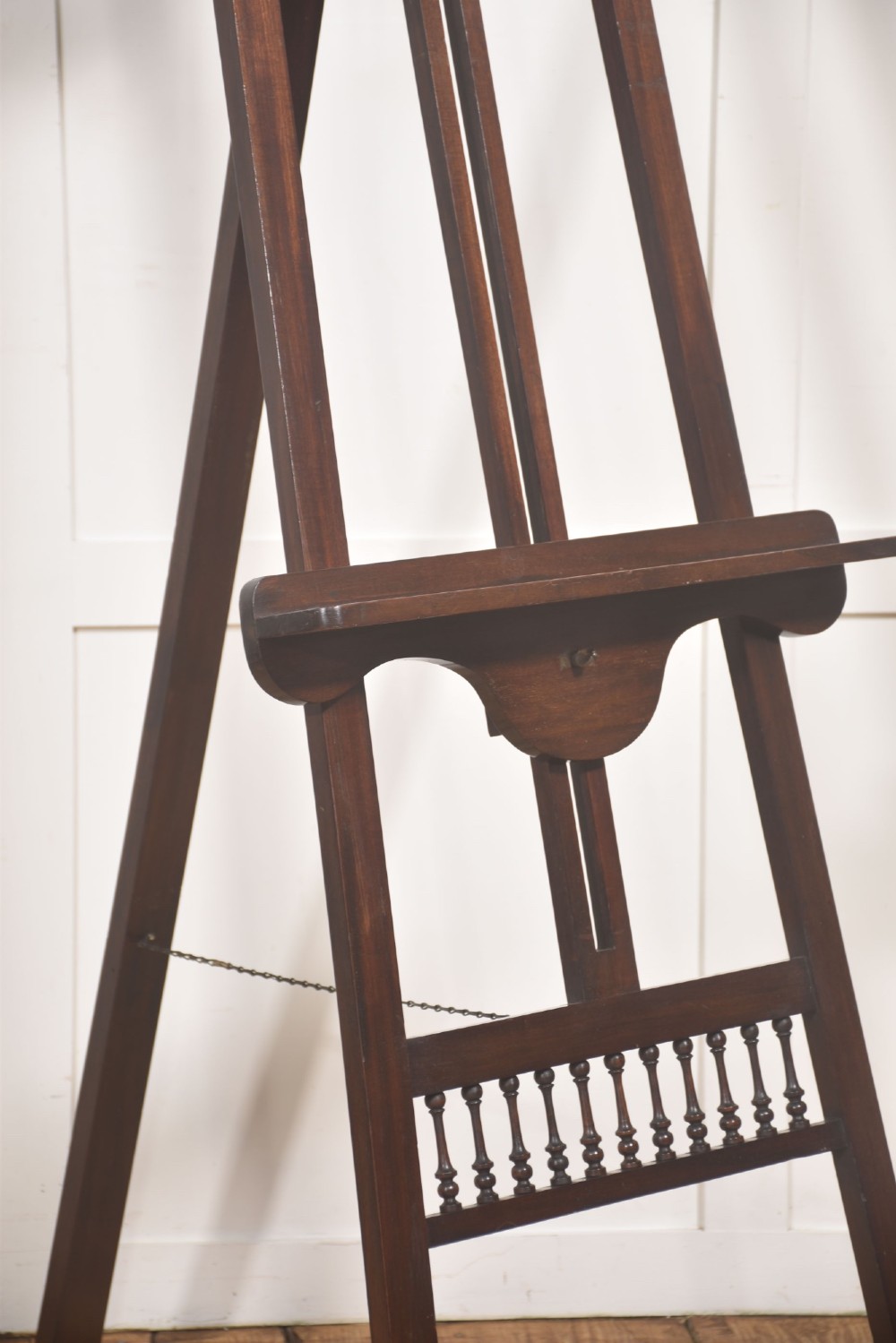 A dark walnut A-frame artist easel featuring Gothic Revival pointed arches, turned spindle galleries, and an adjustable support ledge. View IV
