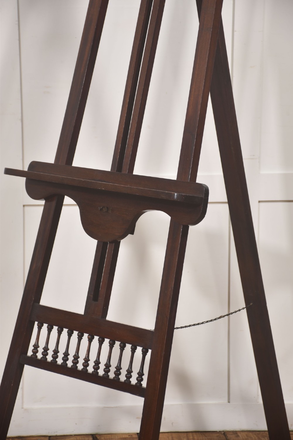 A dark walnut A-frame artist easel featuring Gothic Revival pointed arches, turned spindle galleries, and an adjustable support ledge. View V
