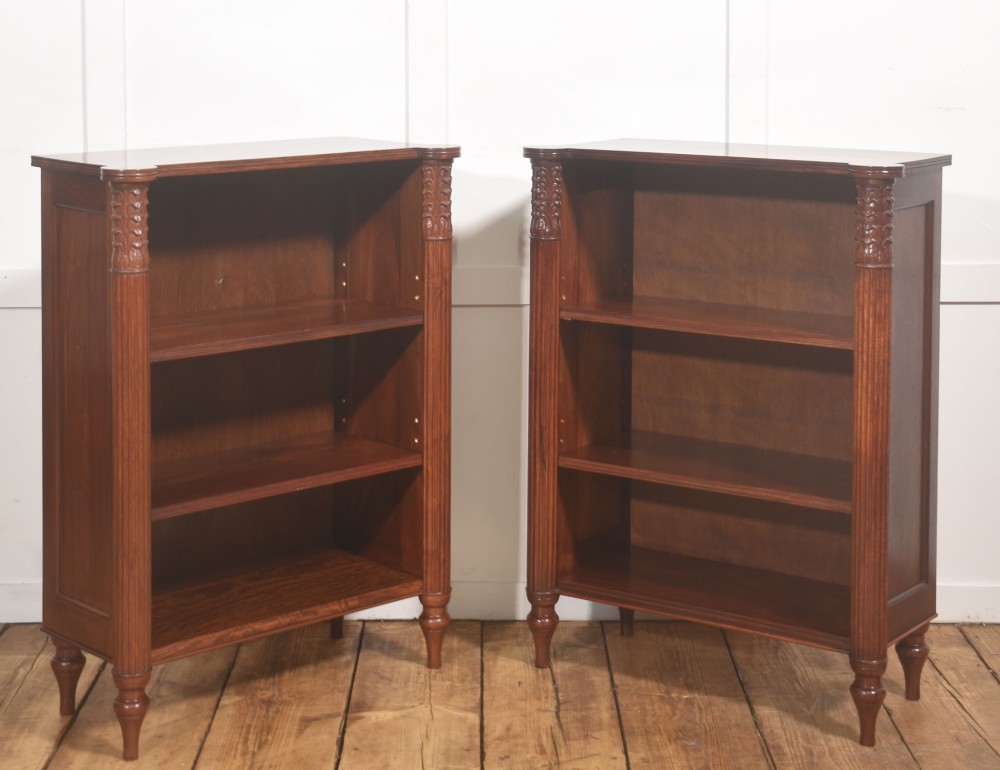 A pair of low mahogany open bookcases featuring fluted pilasters with carved tops, adjustable shelves, and turned legs. View VI