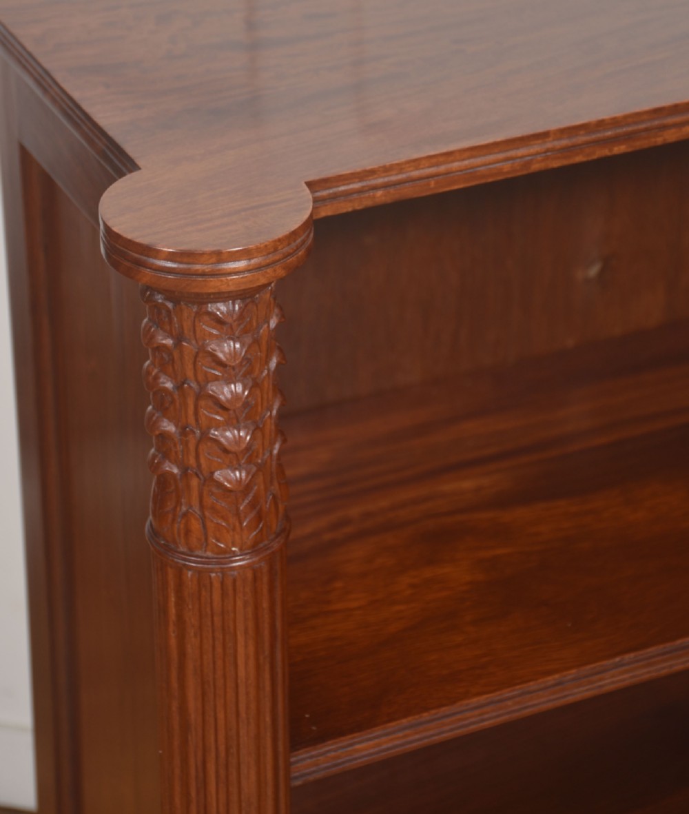 A pair of low mahogany open bookcases featuring fluted pilasters with carved tops, adjustable shelves, and turned legs. View VII