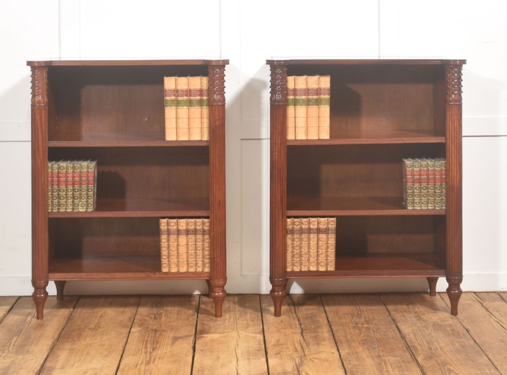 A pair of low mahogany open bookcases featuring fluted pilasters with carved tops, adjustable shelves, and turned legs. View XI