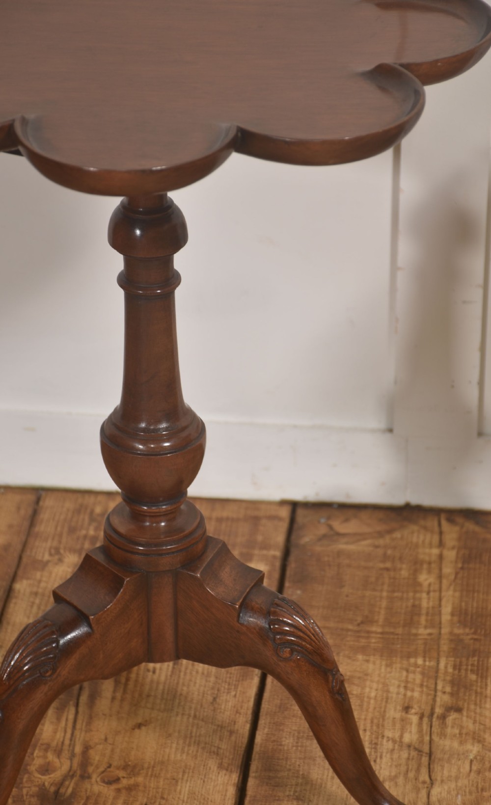 A pair of polished dark mahogany tripod side tables featuring scalloped pie-crust tops, turned central pedestals, and carved cabriole legs. View IV