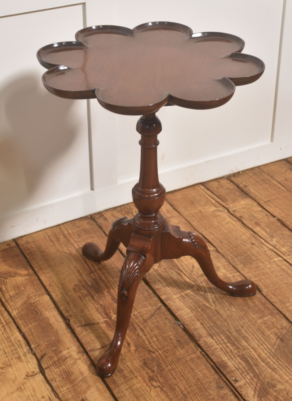 A pair of polished dark mahogany tripod side tables featuring scalloped pie-crust tops, turned central pedestals, and carved cabriole legs. View VII