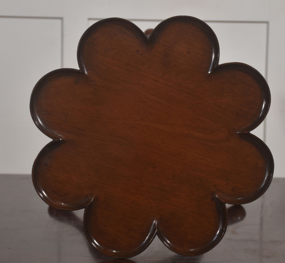 A pair of polished dark mahogany tripod side tables featuring scalloped pie-crust tops, turned central pedestals, and carved cabriole legs. View IX