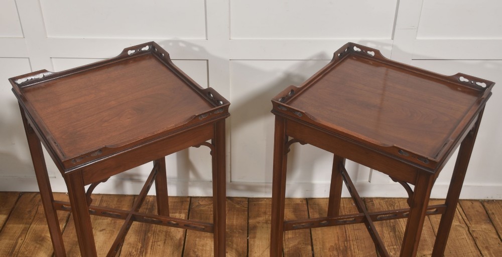 A pair of dark mahogany Edwardian side tables with square tops, pierced fretwork galleries, and cross stretchers. View V