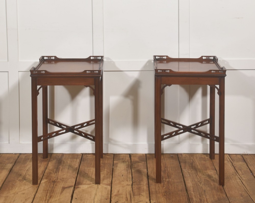 A pair of dark mahogany Edwardian side tables with square tops, pierced fretwork galleries, and cross stretchers. View VI