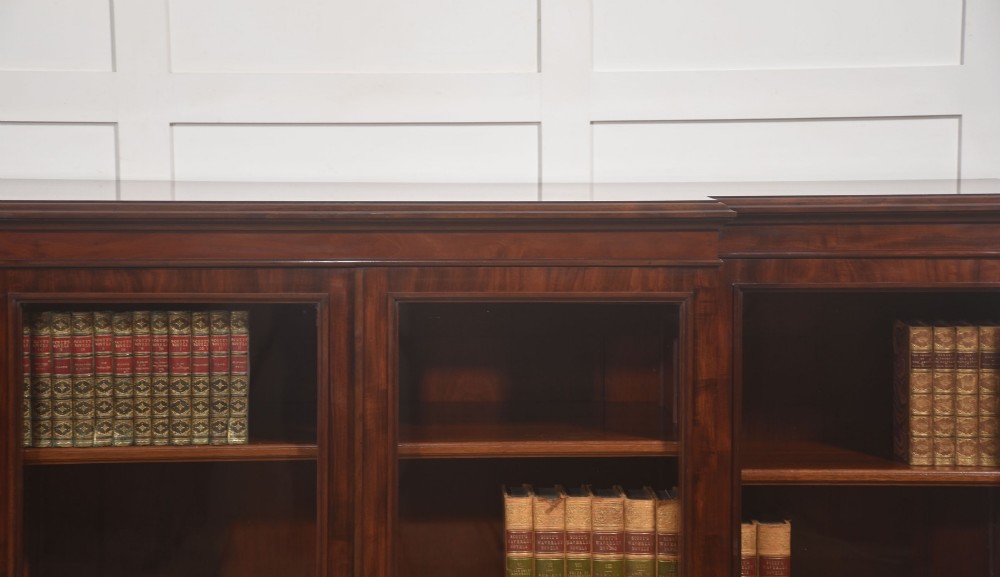 A 19th-century mahogany breakfront library bookcase featuring four glass-panelled doors, adjustable interior shelving, and a moulded cornice. View III