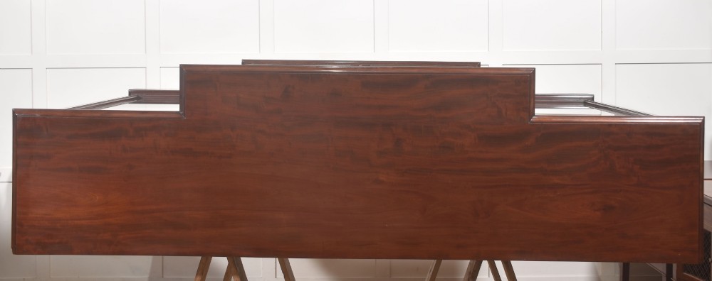 A 19th-century mahogany breakfront library bookcase featuring four glass-panelled doors, adjustable interior shelving, and a moulded cornice. View XIV
