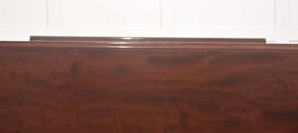 A 19th-century mahogany breakfront library bookcase featuring four glass-panelled doors, adjustable interior shelving, and a moulded cornice. View XV