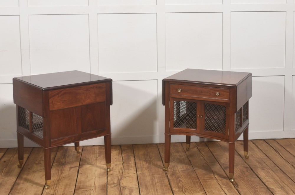 A pair of rosewood drop-leaf side tables featuring single drawers above cupboard doors with brass grille inserts, standing on square tapered legs with brass castors. View VII